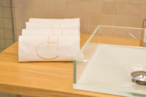 a stack of white towels sitting on a table at Hotel Del Conte in Fondi