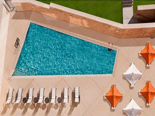 an overhead view of a swimming pool with umbrellas at AT&T Hotel & Conference Center in Austin