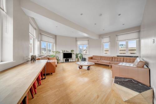 a large living room with a couch and a table at Heart of Shoreditch in London