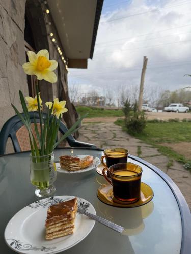 a table with two cups of coffee and some desserts at Saro B&B in Tatev in Tandzatapʼ