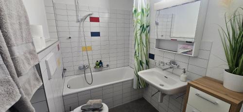 a bathroom with a tub and a sink and a shower at Lake View See & Bergsicht free parking in Kreuzlingen