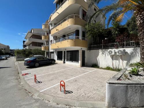 a car parked in a parking lot in front of a building at Makala Accommodation in Split