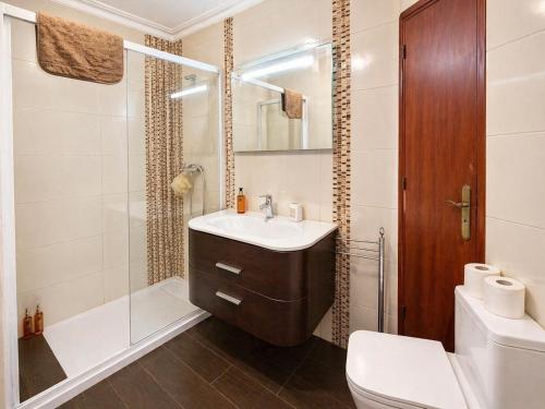 a bathroom with a sink and a shower and a toilet at Baleal Breeze Apartment in Ferrel