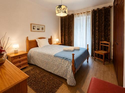 a bedroom with a bed and a large window at Baleal Breeze Apartment in Ferrel