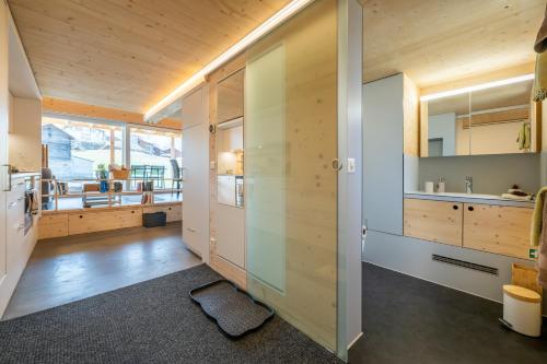 a kitchen with wood paneling and a sliding door at Tiny Bishorn mit privatem Whirlpool in Grächen