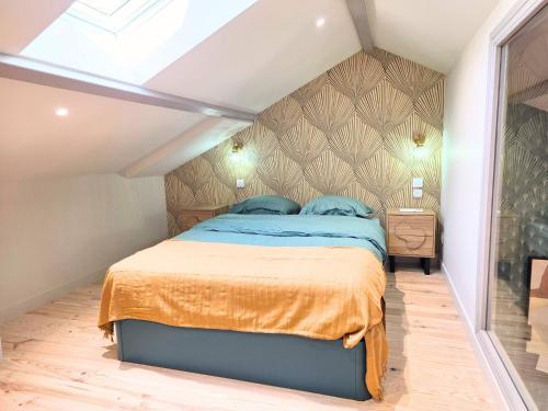 a bedroom with a large bed in a attic at cabane perche duplex st affrique in Saint-Affrique