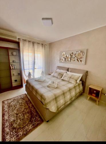 a bedroom with a large bed and a rug at Mirabilia in Maratea