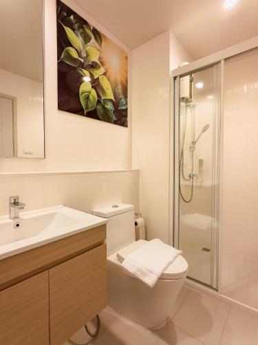 a bathroom with a toilet and a sink and a shower at BLU Diamond Cha Am in Ban Bo Khaem