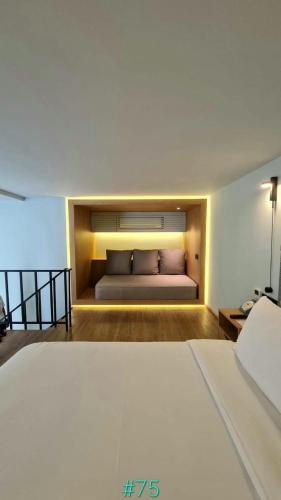 a bed in a room with a large bed sidx sidx sidx at The SACHA Apart-Hotel Thonglor Sukhumvit Bangkok in Bangkok