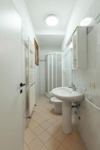 a white bathroom with a sink and a toilet at Residence azzurro VISTA MARE-A in Gabicce Mare