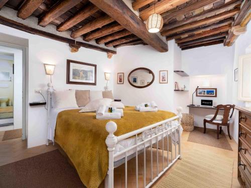 a bedroom with a large bed in a room with wooden ceilings at Casa Alberi in Volterra