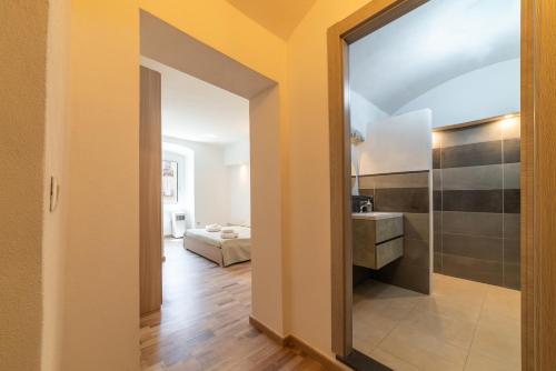 a hallway with a door leading to a bedroom at Sardinian Gallery Sa Funtana in Bosa
