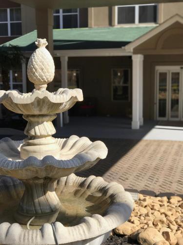 a stone fountain in front of a house at Country Inn & Suites by Radisson, Dalton, GA in Dalton