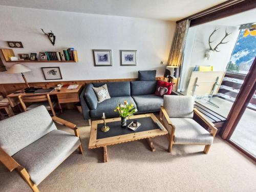 a living room with a couch and two chairs and a table at Apartment Apt A 086 by Interhome in Disentis