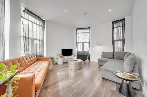 a living room with a couch and a table at Heart of Shoreditch in London