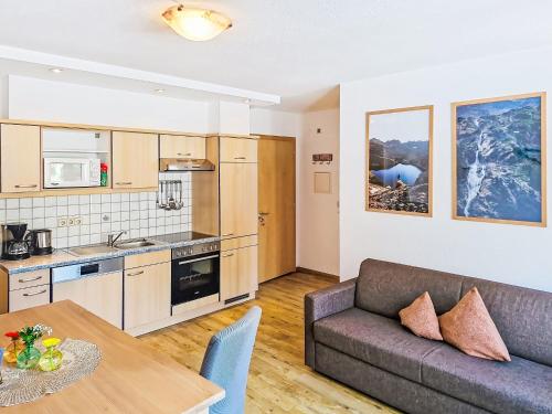 a living room with a couch and a table at Apartment Handle-2 by Interhome in Ried im Oberinntal