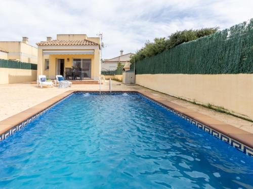 a swimming pool in the backyard of a house at Holiday Home Flamenc 1 by Interhome in Riumar