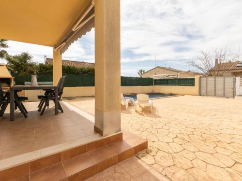 a patio with a table and chairs and a pool at Holiday Home Flamenc 1 by Interhome in Riumar