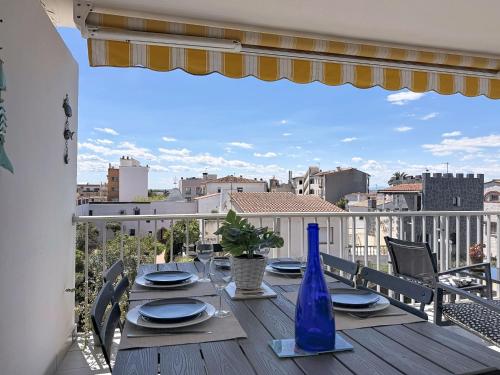 a table on a balcony with a view of the city at Apartment Pattaya-8 by Interhome in Empuriabrava
