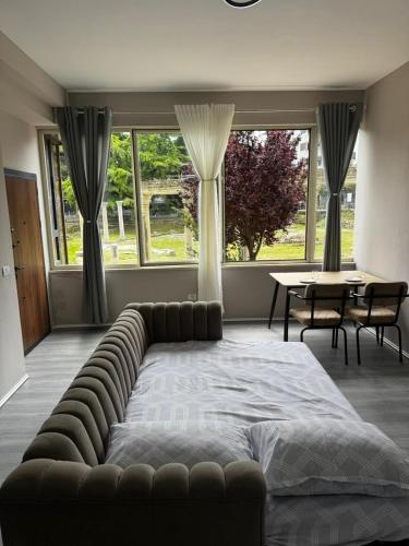 a bedroom with a large bed and a table and chairs at Forum View 2 in Durrës