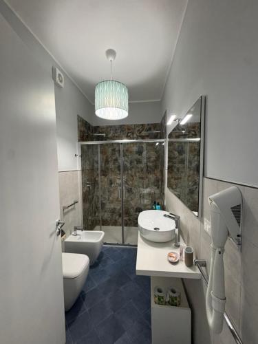 a bathroom with a toilet and a sink and a shower at San Pietro Otranto in Otranto