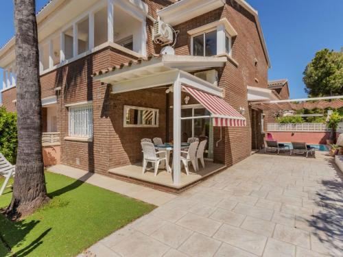 a house with a patio with a table and chairs at Holiday Home Canyadell by Interhome in Torredembarra