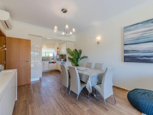 a kitchen and dining room with a table and chairs at Apartment Jardins Marina T2 - VIP Properties by Interhome in Albufeira