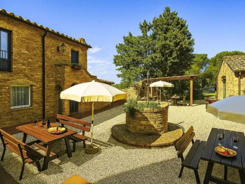 a patio with tables and umbrellas in front of a building at Apartment Siena by Interhome in Vergelle