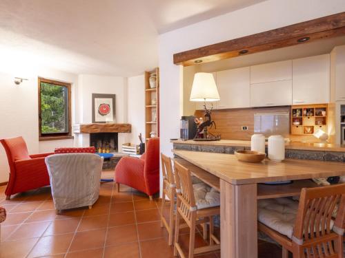 a kitchen and living room with a table and chairs at Apartment La Marmotta by Interhome in Madesimo