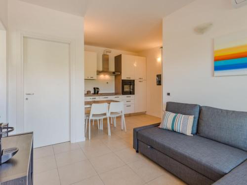 a living room with a couch and a kitchen at Apartment Sole e Fiori by Interhome in Domaso
