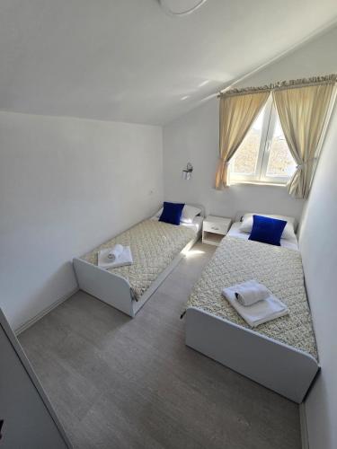 a room with two beds and a window at Seba Apartments in Korčula
