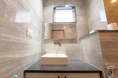a bathroom with a sink and a mirror at Mandala Living Kathmandu in Kathmandu