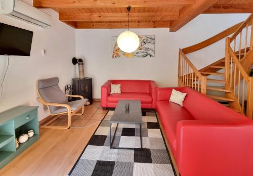 a living room with a red couch and a table at Haus 11 Außergewöhnlich schön gelegen Natur Ferienpark im Teutoburger Wald in Nieheim