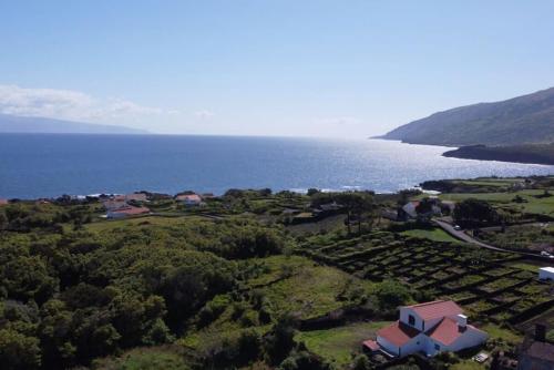 an aerial view of a house next to the ocean at Liiiving in Açores - Ocean View House in Canto da Areia