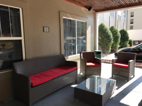a porch with a couch and two chairs and a table at Country Inn & Suites by Radisson, Dalton, GA in Dalton