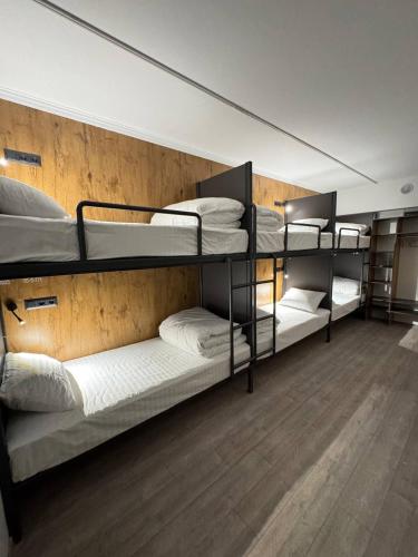 a room with three bunk beds in a room at Generator Tashkent Hostel in Tashkent