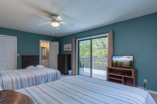 a bedroom with two beds and a sliding glass door at Home Away From Home · Home-Away-From-Home in Rosman