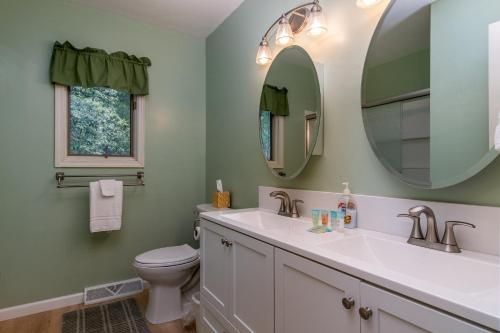 a bathroom with a sink and a toilet and a mirror at Home Away From Home · Home-Away-From-Home in Rosman