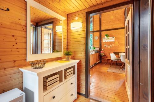 a bathroom in a log cabin with a sink and a mirror at Chalet 22 Bernau in Bernau im Schwarzwald