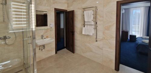 a bathroom with a sink and a shower and a sink at Kozatskiy Hotel in Kyiv