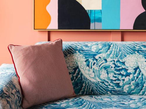 a pillow sitting on top of a bed with a painting at The Dean Galway in Galway