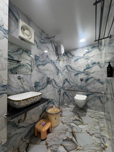 a bathroom with a sink and a toilet at Hotel The Avanta- Naroda in Naroda