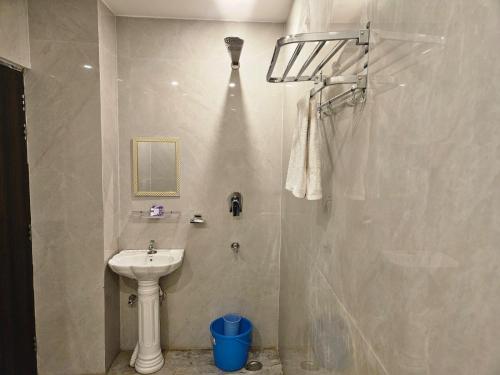 a bathroom with a sink and a shower at Royal Guest House in Jammu