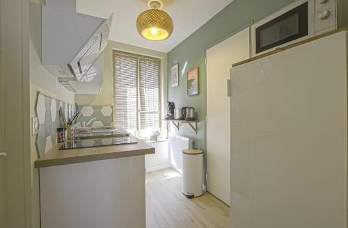 a kitchen with a sink and a counter top at Le Cocon de Nuit Normande in Étretat