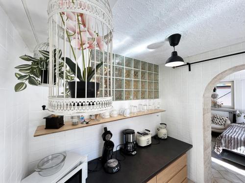 a kitchen with a vase with pink flowers in it at Schwarzwald Glück in Bühl