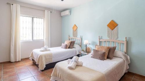 two beds in a room with blue walls at Casa Corazón 44 Torrox by Ruralidays in Torrox