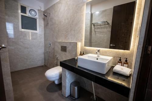 a bathroom with a sink and a toilet at Foxoso Heights, Tapovan in Rishīkesh
