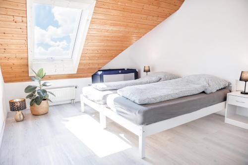 a bedroom with two beds and a window at Wohnung am Bodensee in Moos