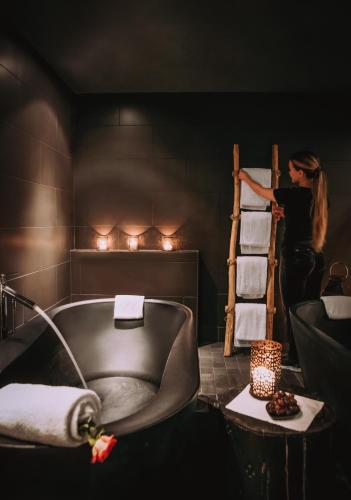 a woman standing next to a towel ladder in a bathroom at Norefjell Ski & Spa in Noresund