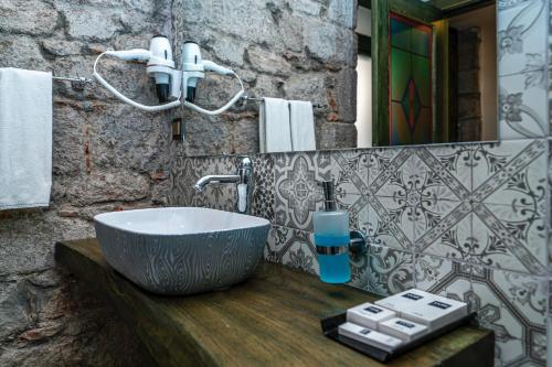 a bathroom with a bowl sink on a wooden counter at Assos Behram Special Class Hotel Adults Only in Behramkale